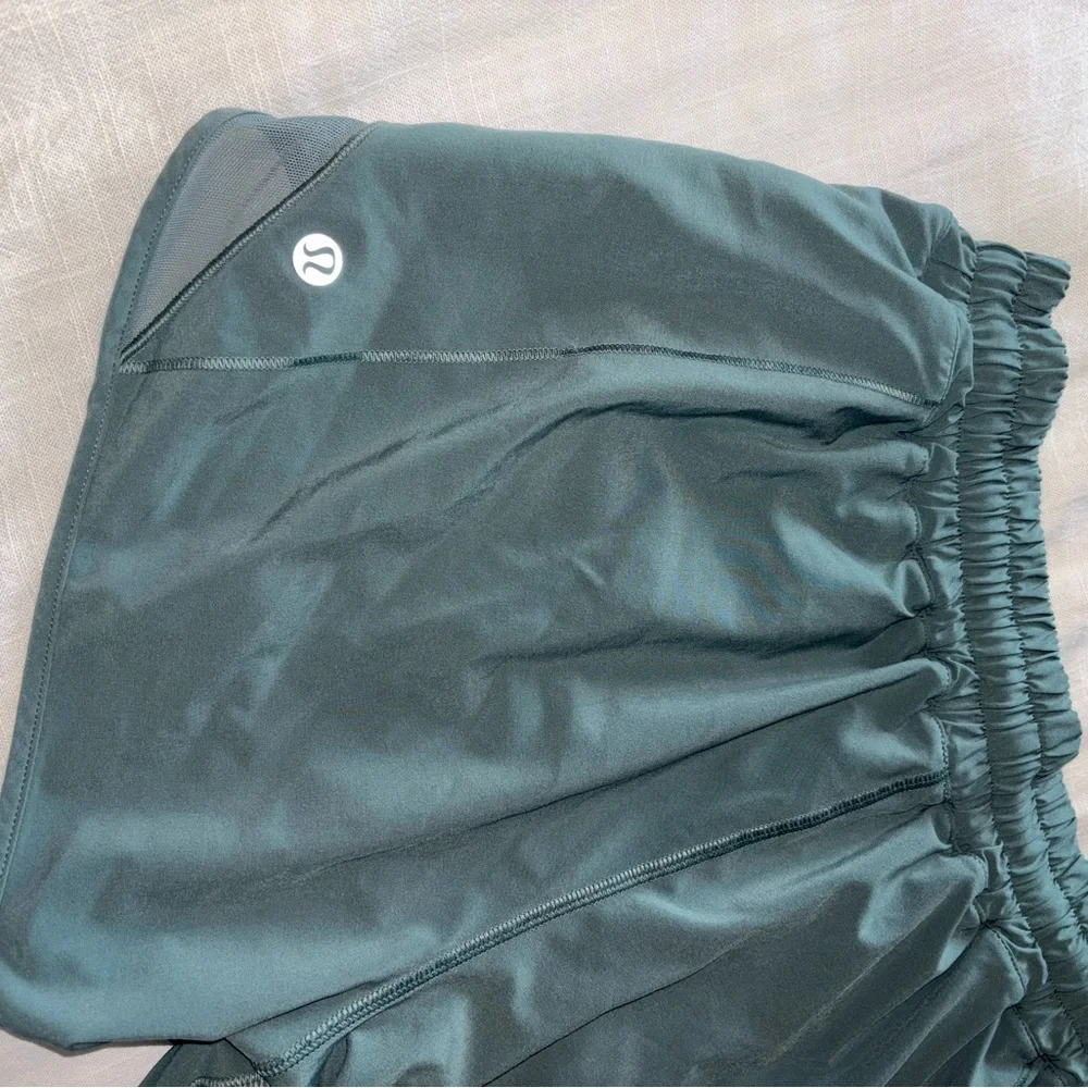 lululemon athletica dark green athletic shorts with reflective accents